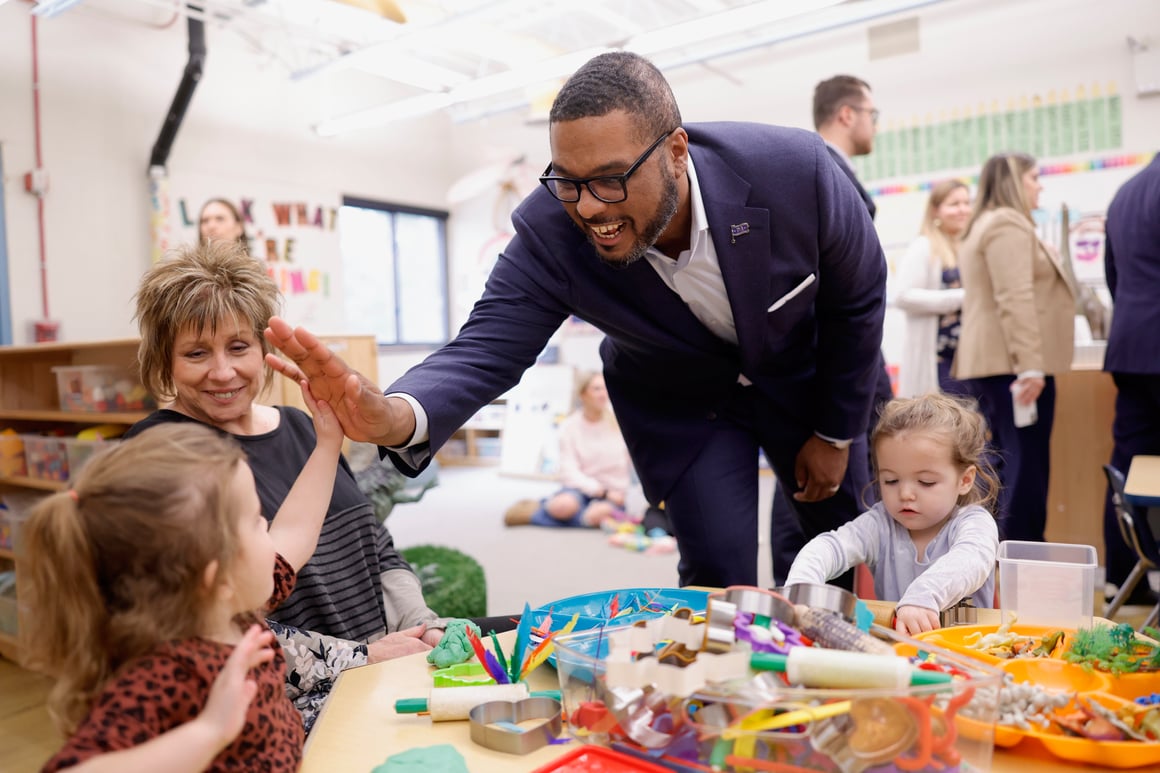 LG high five at child care center Photo: Commonwealth Media Services
